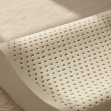 Close-up of a beige perforated latex pillow core.