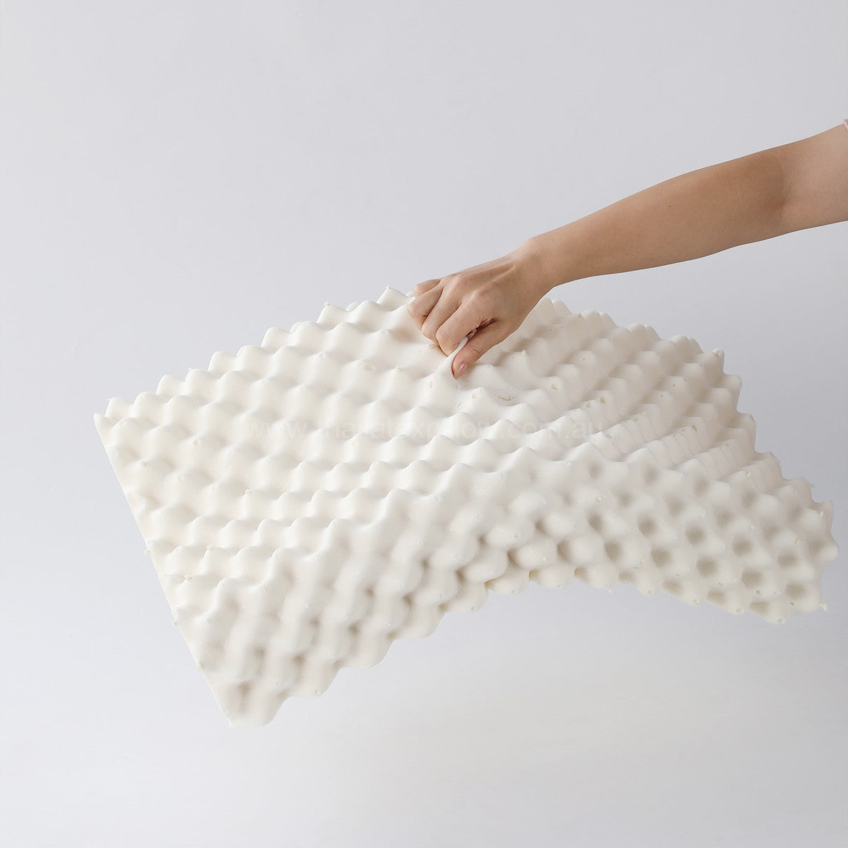 Hand lifting the pillow - PAPATYA Latex Neck Pillow Contour Support with Massage Nodules