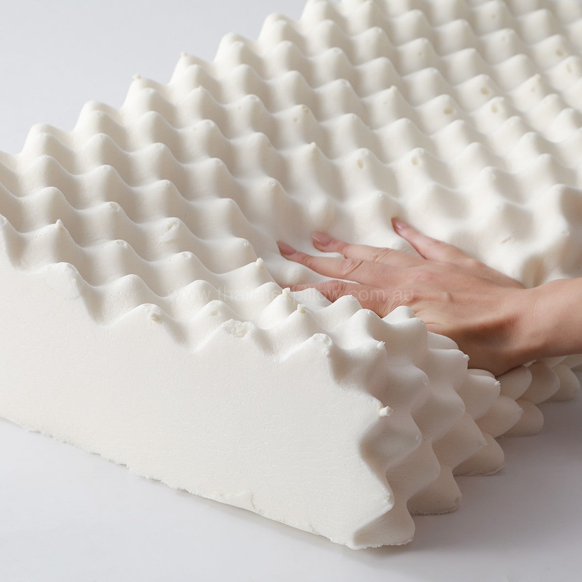 Hand pressing the pillow - PAPATYA Latex Neck Pillow Contour Support with Massage Nodules