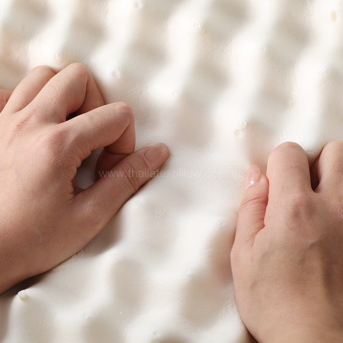 Hand sliding across the pillow surface - PAPATYA Latex Neck Pillow Contour Support with Massage Nodules